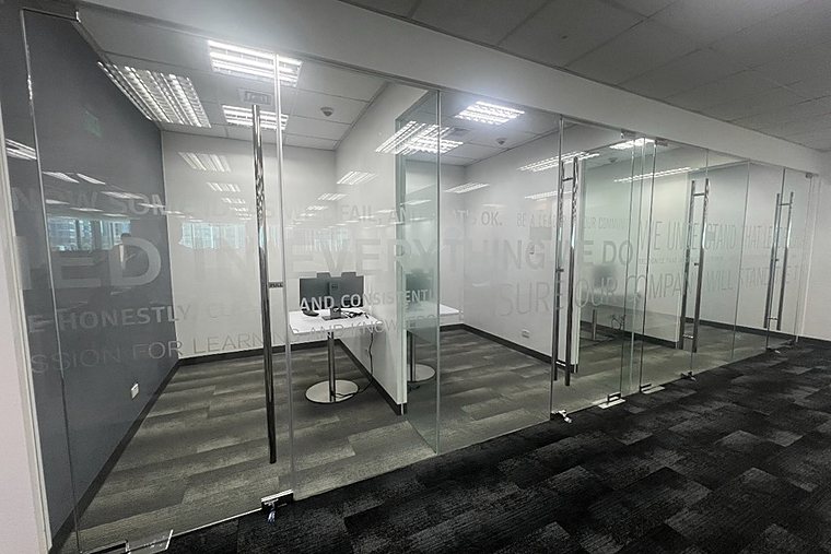 A row of rooms separated by glass partitions.